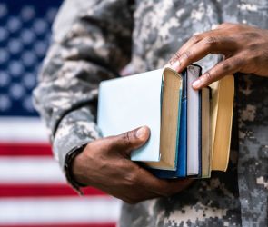 Veteran holding books